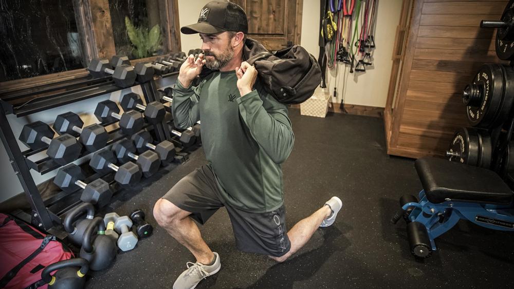 Will Schmidt demonstrating one of the top 5 exercises for packing training - lunges with a backpack.