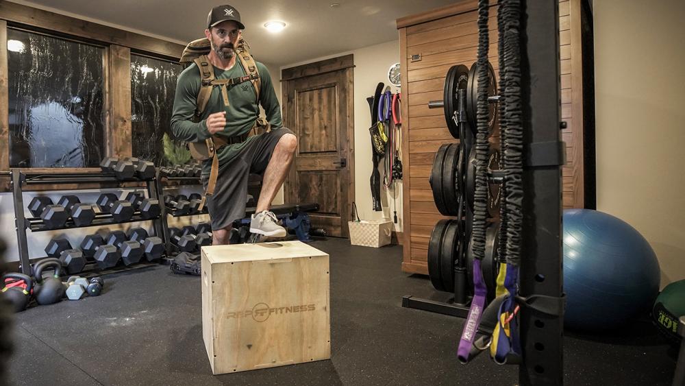 Wille Schmidt demonstrating one of the top 5 exercies for pack training - box steps with a backpack.