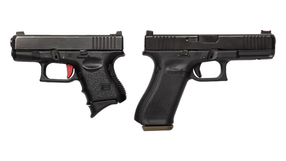 A display of a small and a large handgun to demonstrate size.