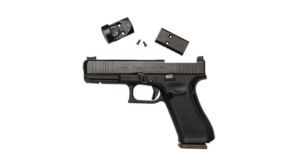 A display of a handgun and a red dot with plate and screws.