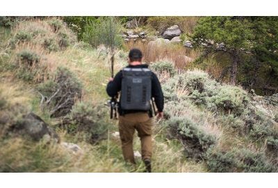 Hunter walking through woods.