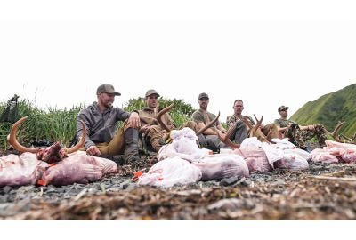 Vortex Hunts Hawaii - 5 Dudes sitting on mountainside with harvested Sitka Blacktail Deer