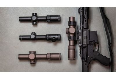 Studio image of 4 Vortex riflescopes on a gray background