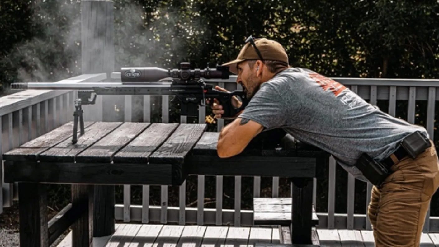 Competitive shooter Tucker Schmidt shooting a gun.