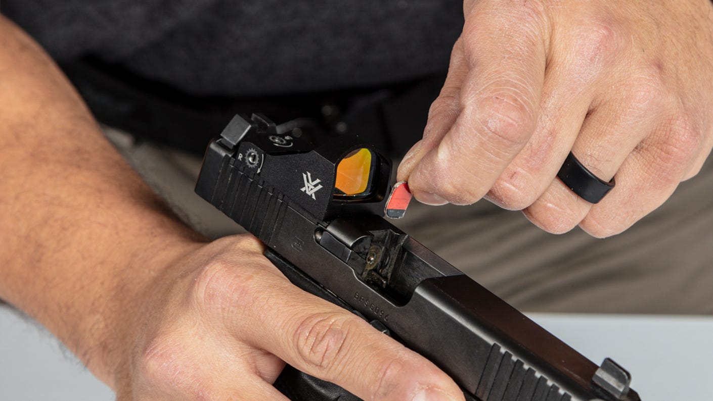 Inserting a small piece of cardboard to keep your gun out of battery.