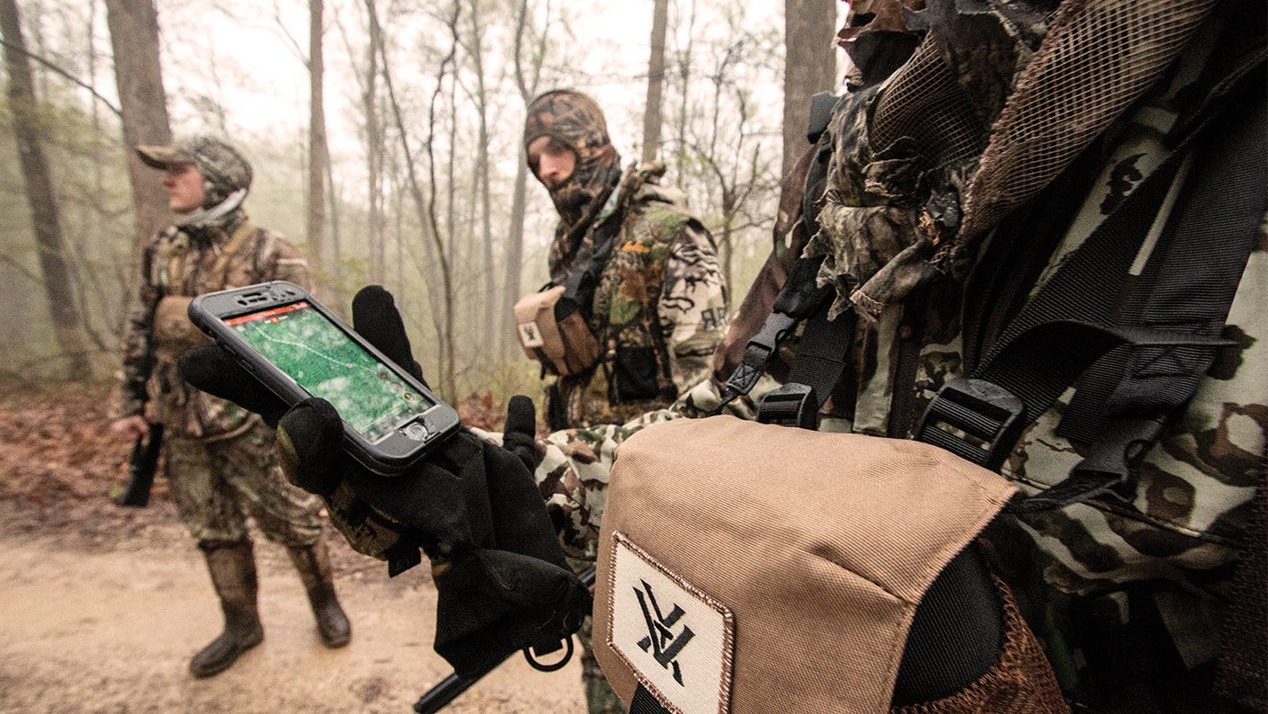 Hunter using a digital mapping application to pinpoint an animals location.